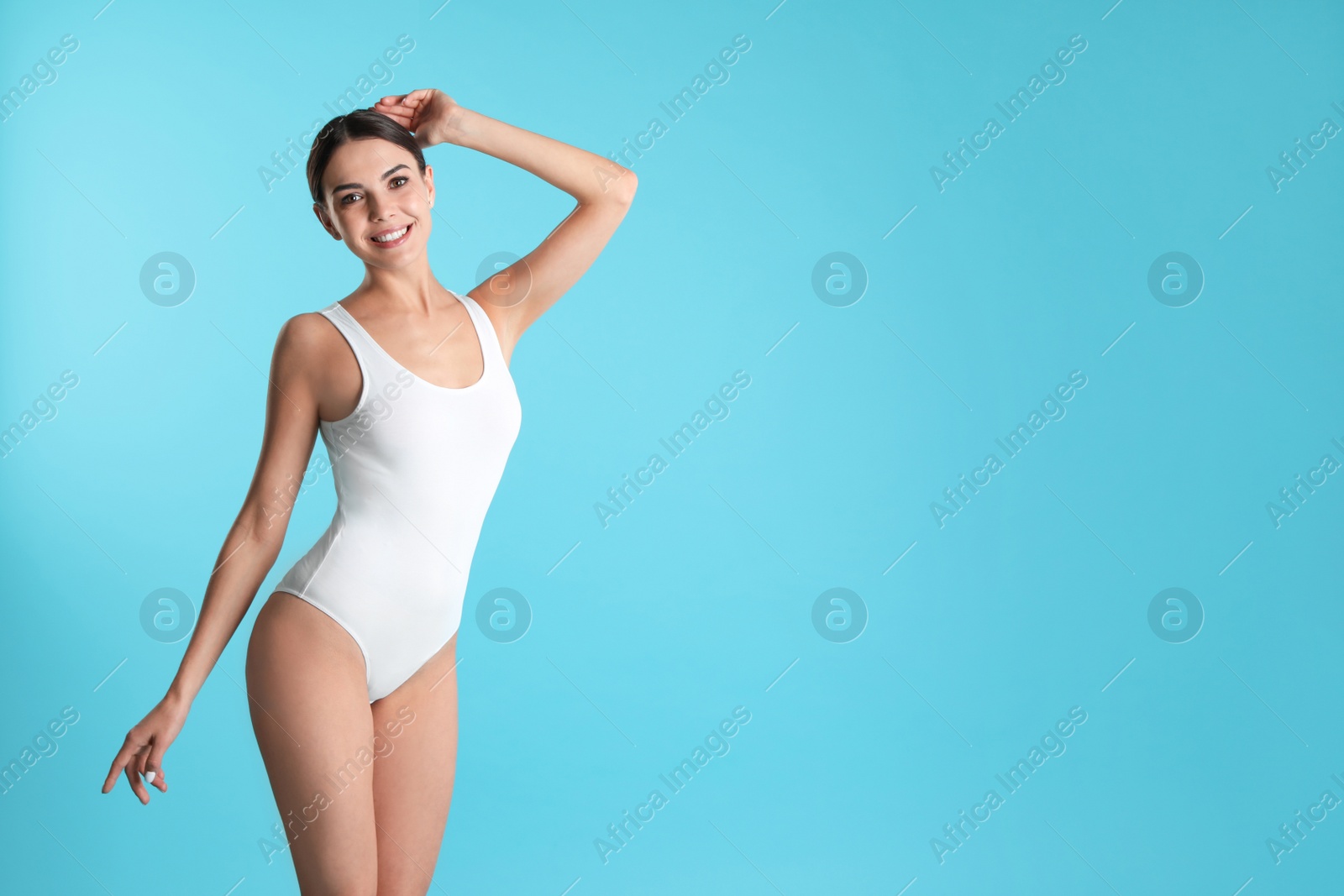 Photo of Portrait of attractive young woman with slim body in swimwear on color background. Space for text