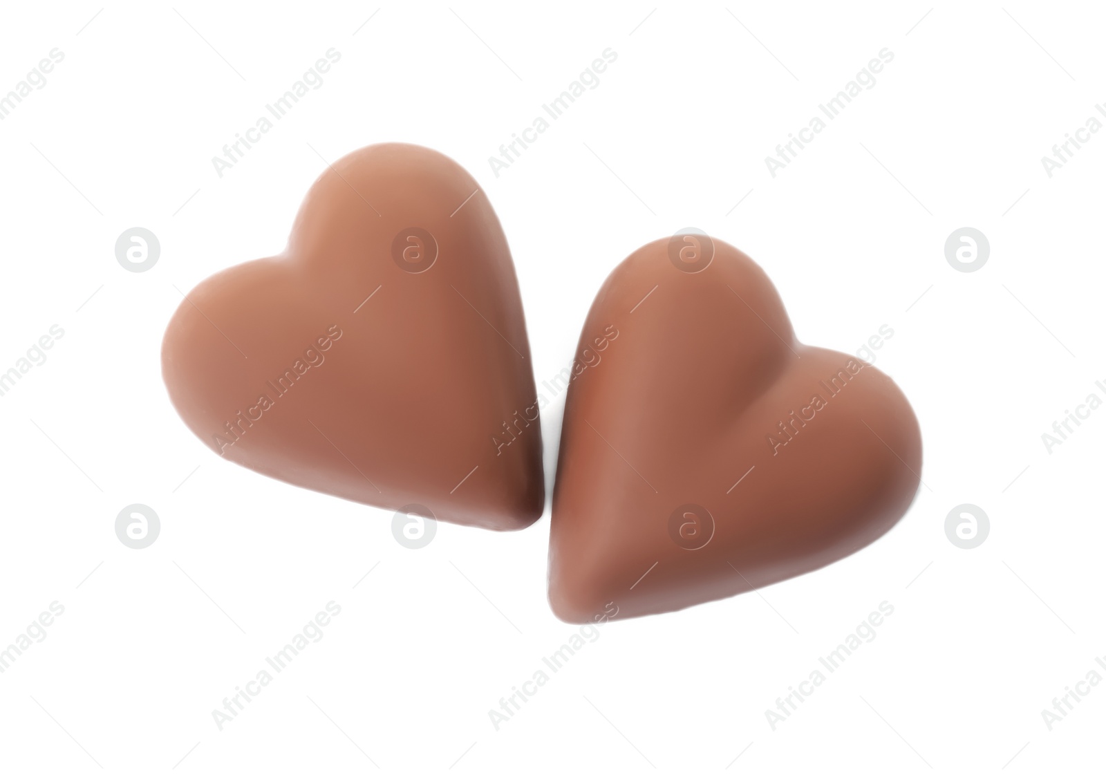 Photo of Tasty heart shaped chocolate candies on white background, top view. Valentine's day celebration