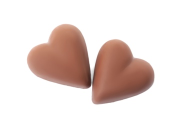 Photo of Tasty heart shaped chocolate candies on white background, top view. Valentine's day celebration