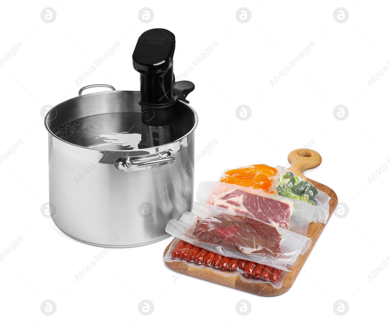 Photo of Thermal immersion circulator in pot and vacuum packs with different food products on white background. Sous vide cooking