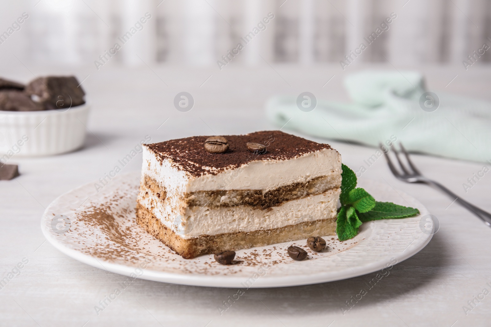 Photo of Tiramisu cake with coffee beans on table