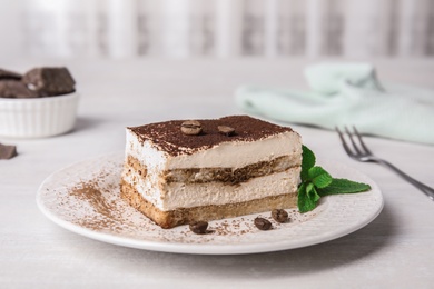 Photo of Tiramisu cake with coffee beans on table