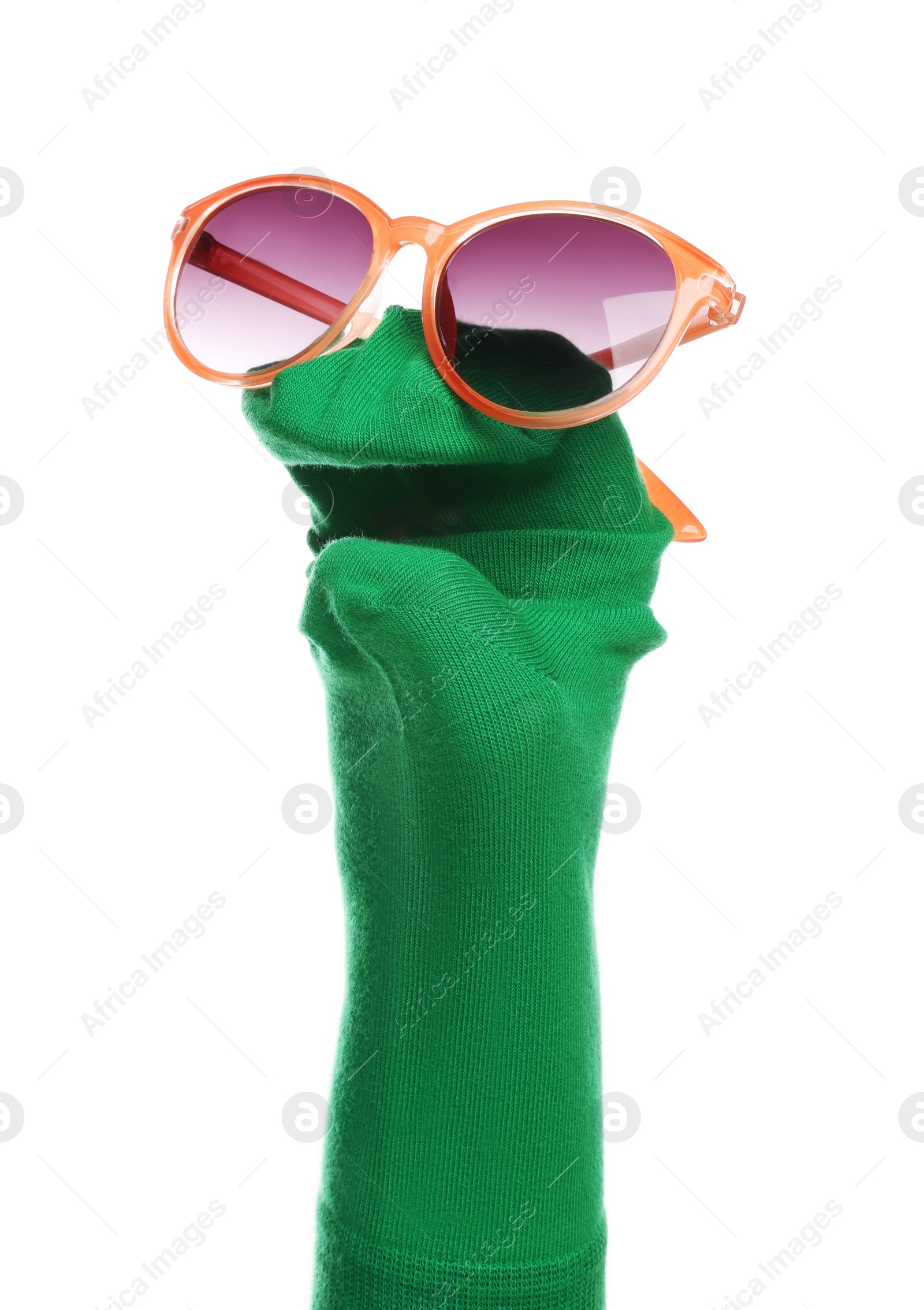 Photo of Funny sock puppet with sunglasses isolated on white