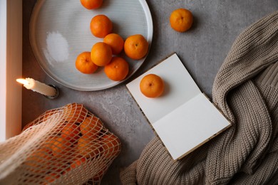 Photo of Flat lay composition with fresh ripe tangerines and book on light grey table