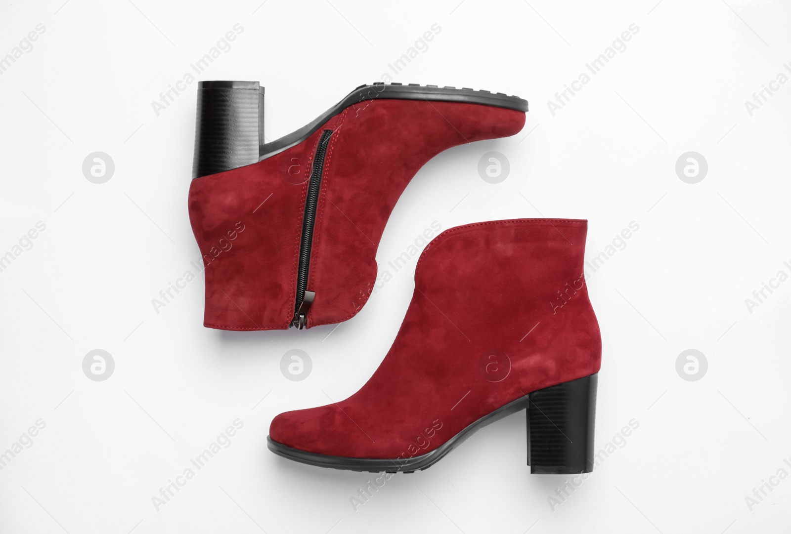 Photo of Stylish red female boots on white background, top view