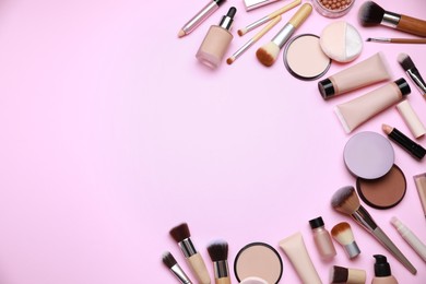 Face powders and other decorative cosmetic products on pink background, flat lay. Space for text