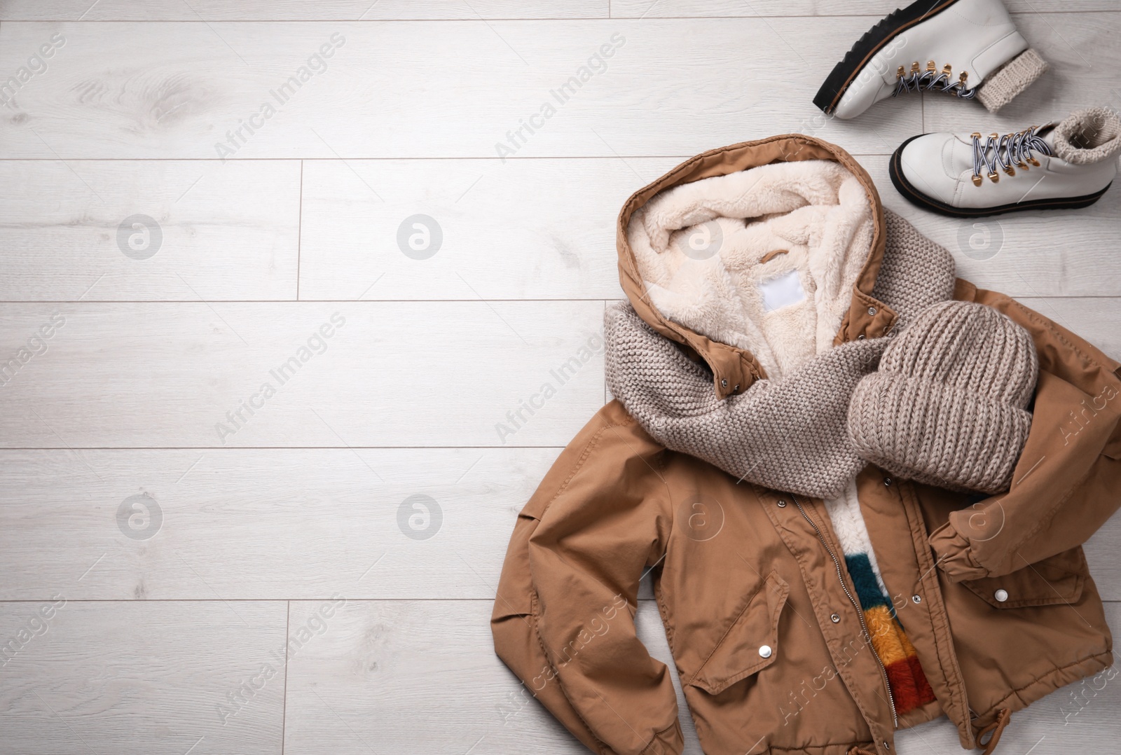 Photo of Winter fashion. Layout with women's outfit on white wooden background, top view. Space for text