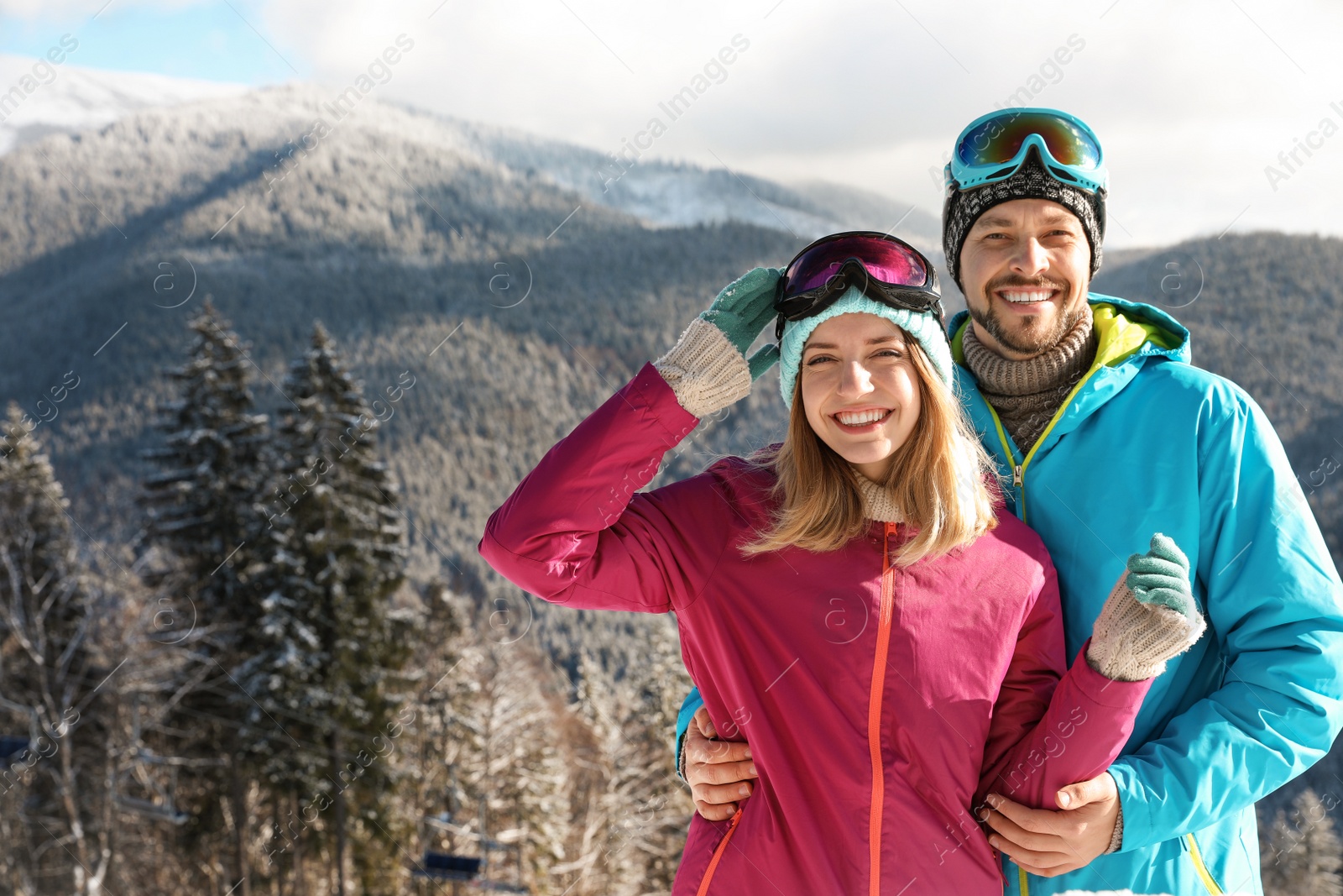 Photo of Happy couple spending winter vacation in mountains. Space for text