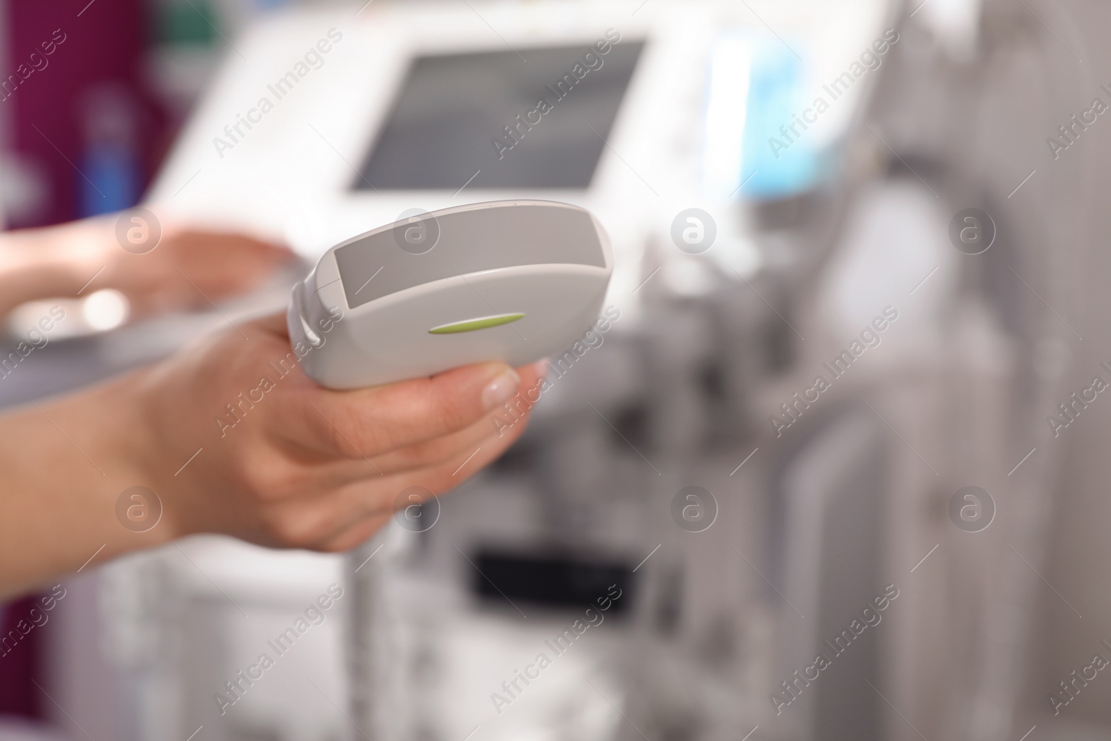Photo of Sonographer holding ultrasound machine probe in clinic, closeup with space for text