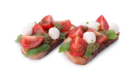 Photo of Delicious Caprese sandwiches with mozzarella, tomatoes, basil and pesto sauce isolated on white