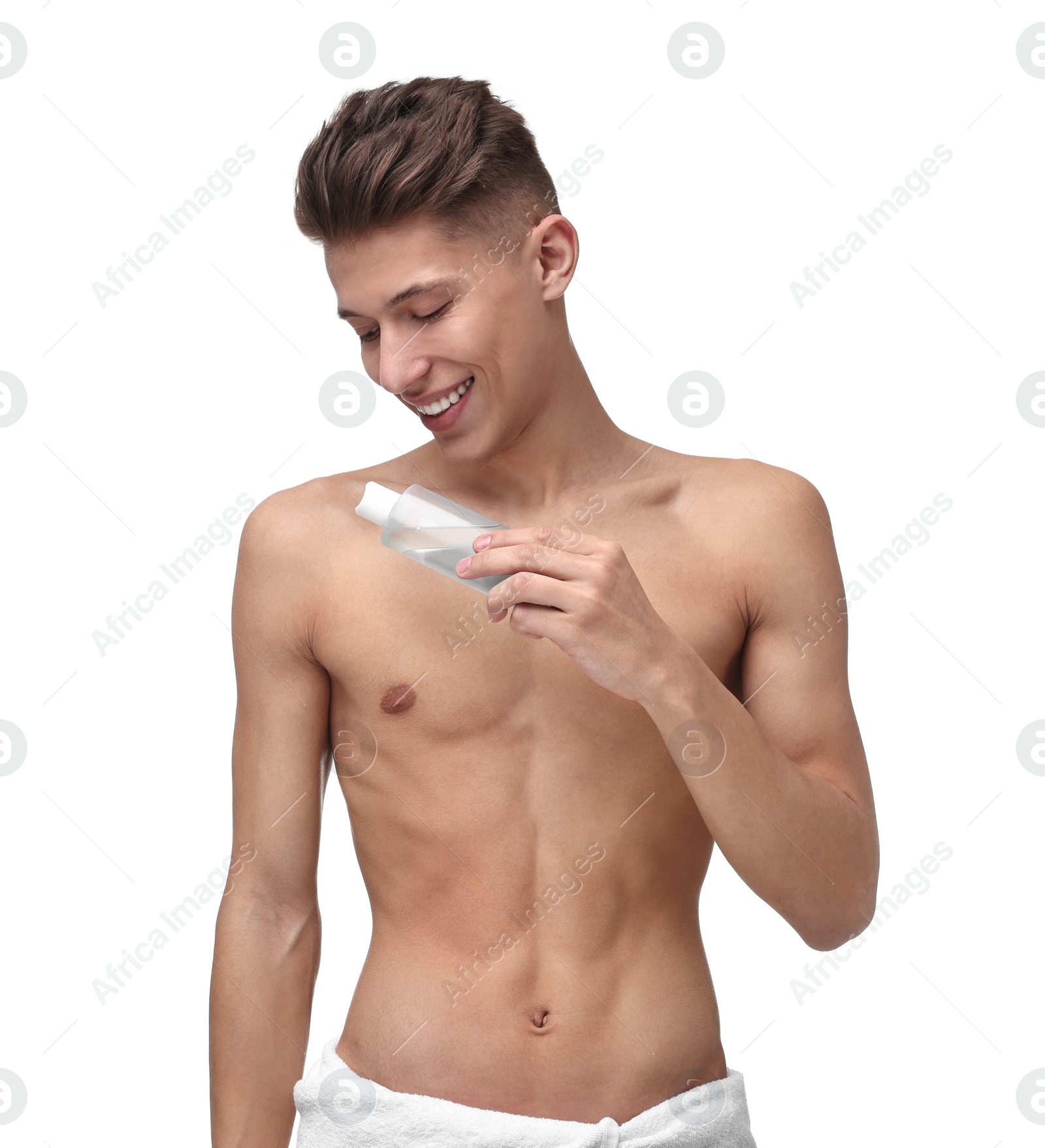Photo of Handsome man applying lotion onto his body on white background