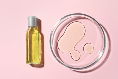 Photo of Petri dish and cosmetic product on pink background, flat lay