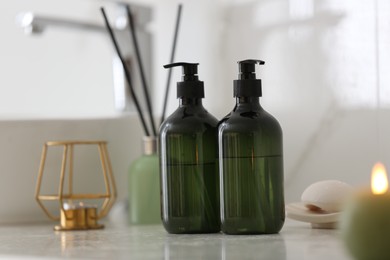 Green soap dispensers on white countertop in bathroom