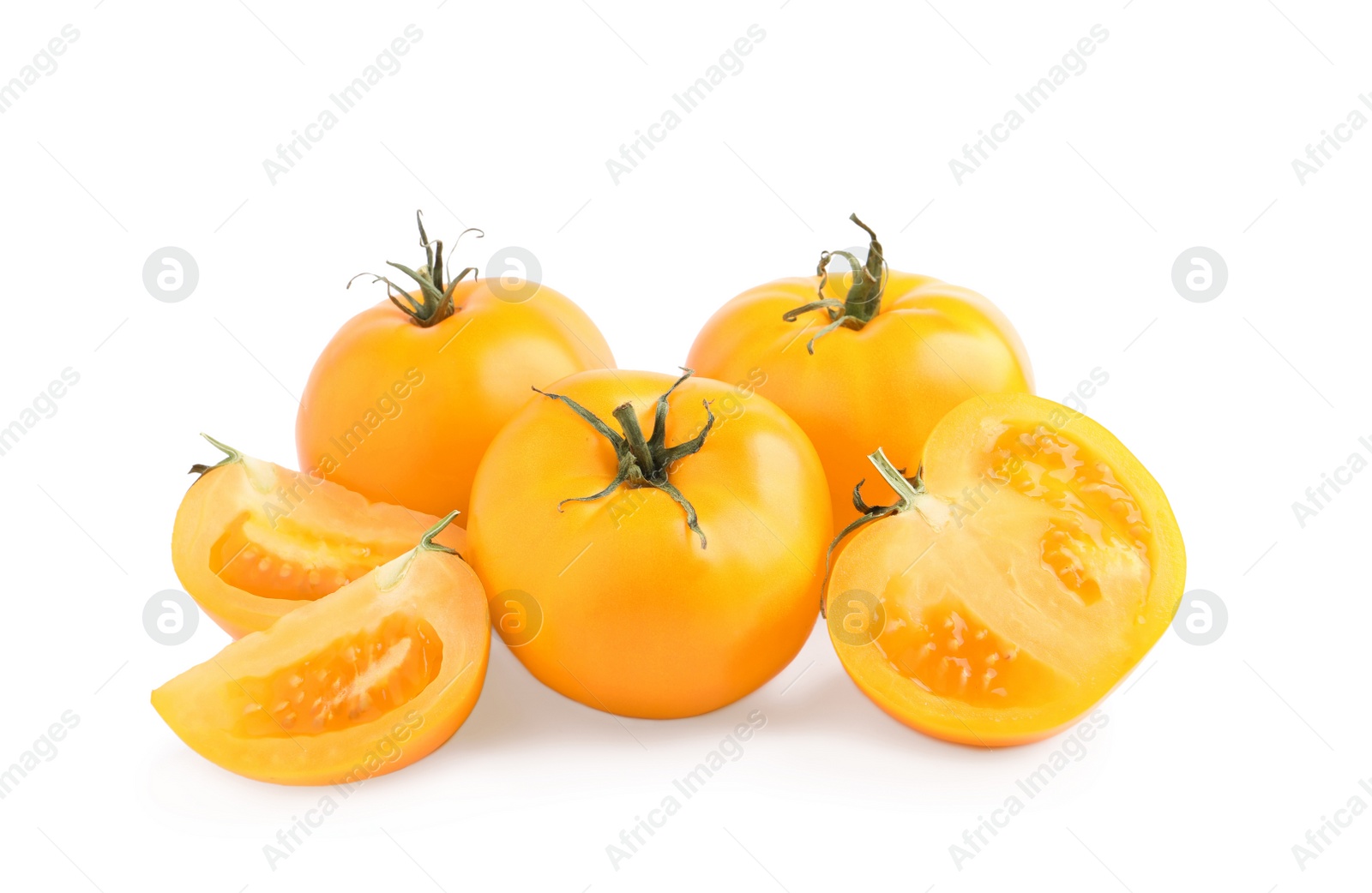 Photo of Cut and whole yellow tomatoes on white background