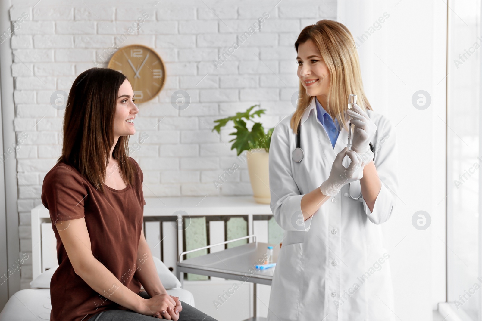 Photo of Doctor vaccinating female patient in clinic