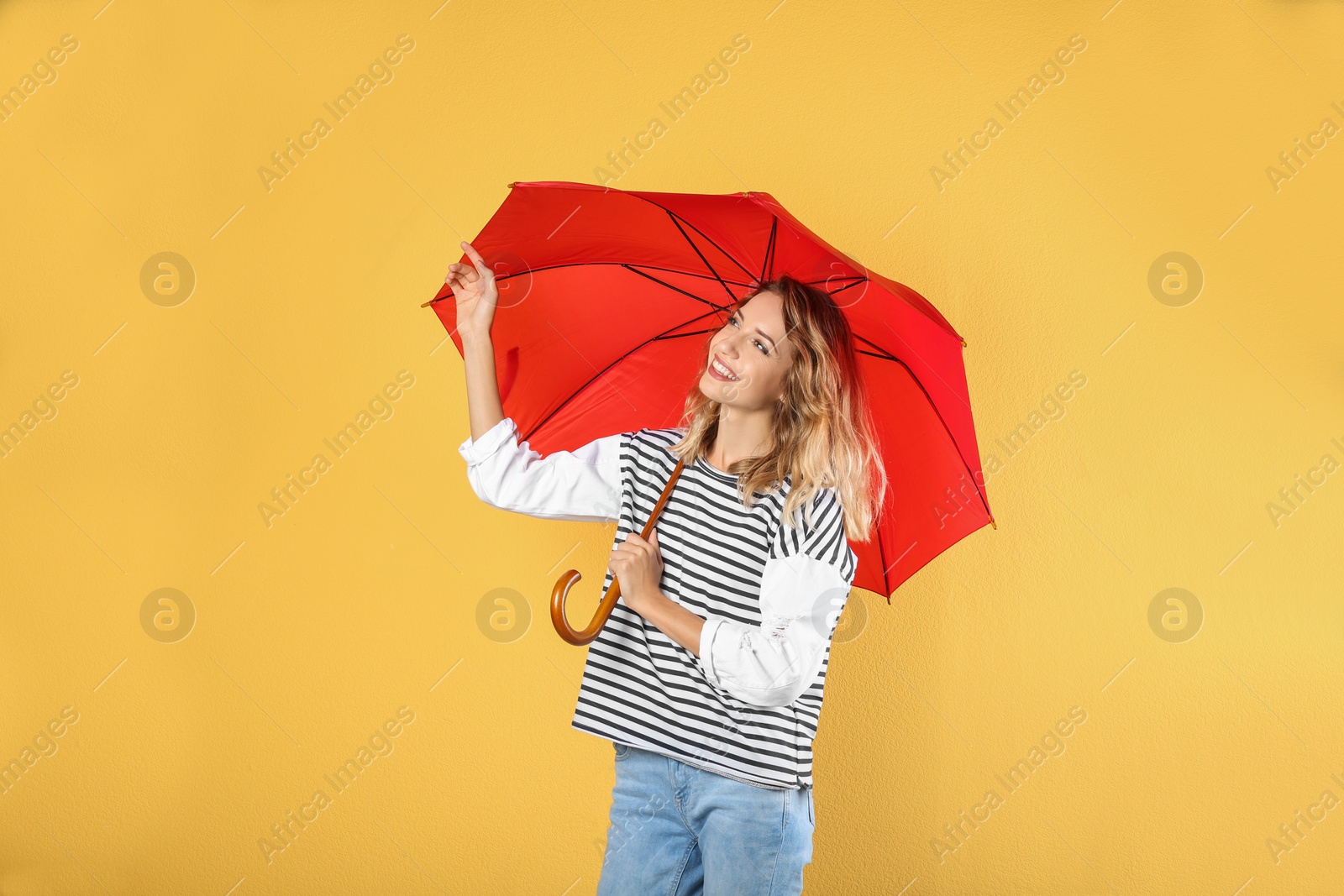 Photo of Woman with red umbrella on color background