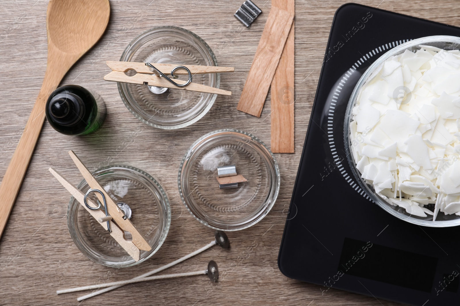 Photo of Flat lay composition with ingredients for homemade candles on wooden background