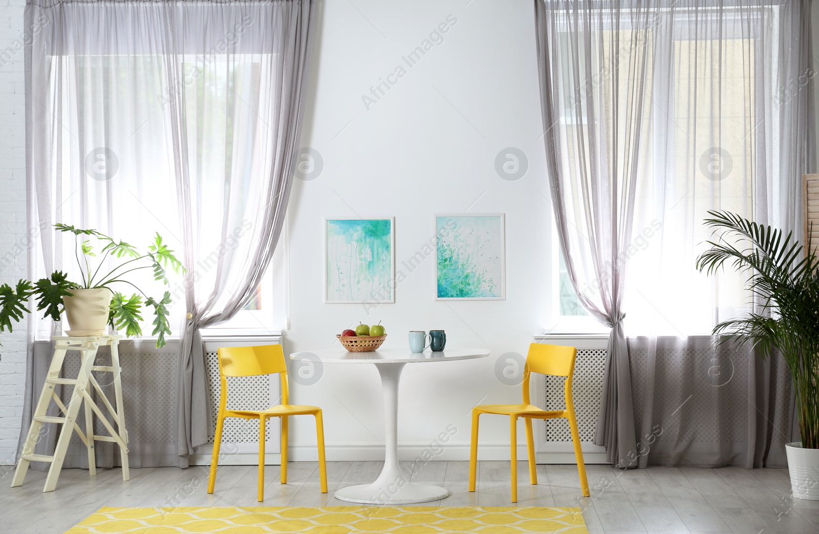 Photo of Room with comfortable table, chairs and stylish decor. Idea for interior design