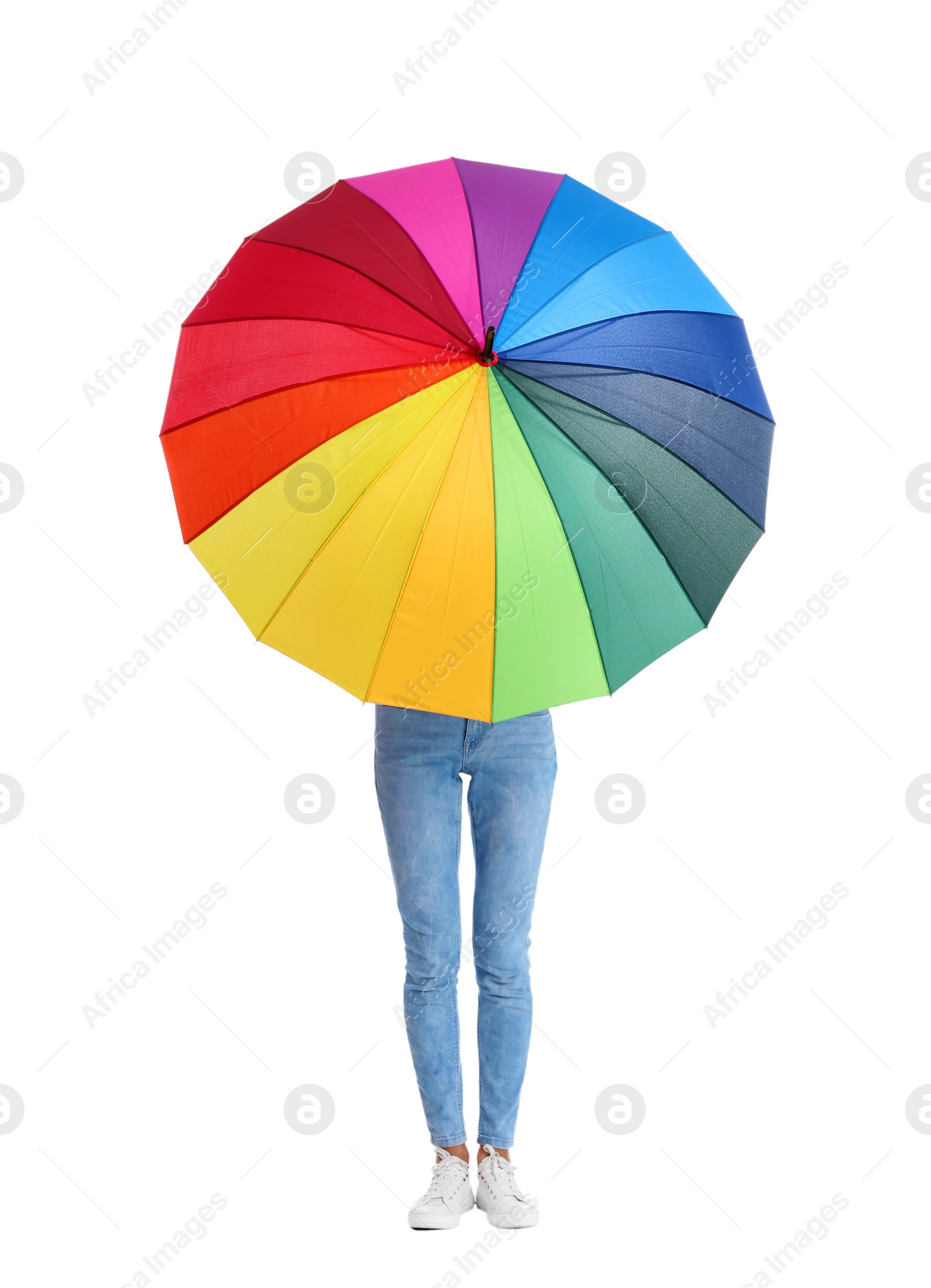 Photo of Woman hiding behind rainbow umbrella on white background