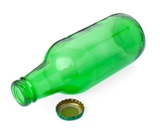 Photo of One empty green beer bottle and cap isolated on white