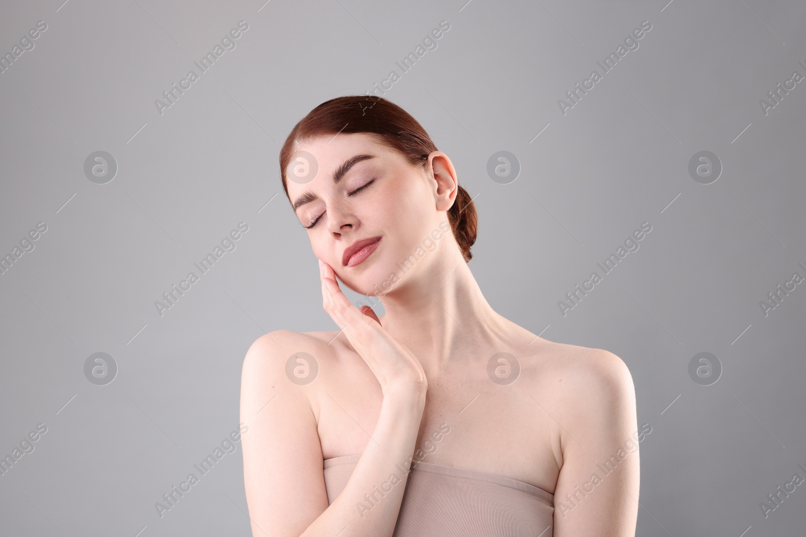 Photo of Portrait of beautiful woman on grey background