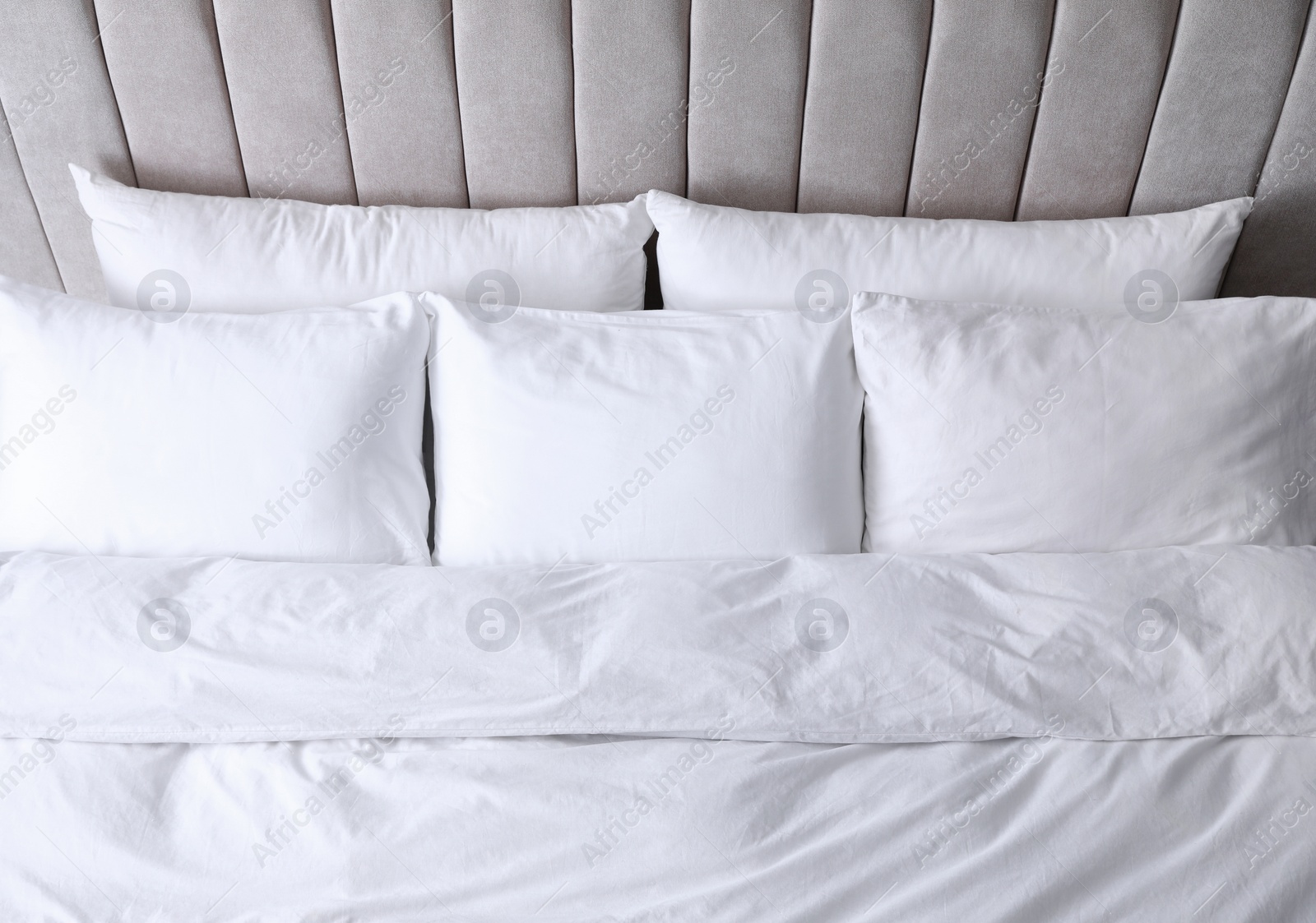 Photo of Comfortable bed with soft pillows, above view