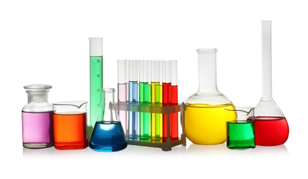 Photo of Laboratory glassware with colorful liquids on white background