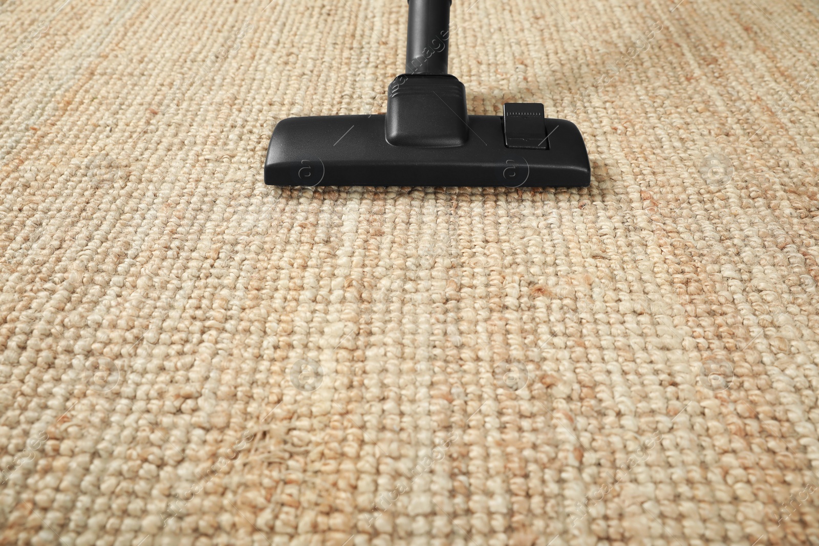 Photo of Removing dirt from beige carpet with modern vacuum cleaner. Space for text