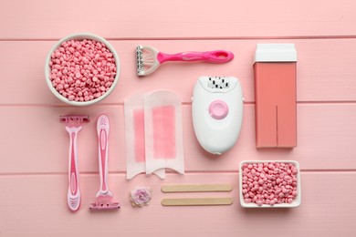 Set of epilation products on pink wooden table, flat lay