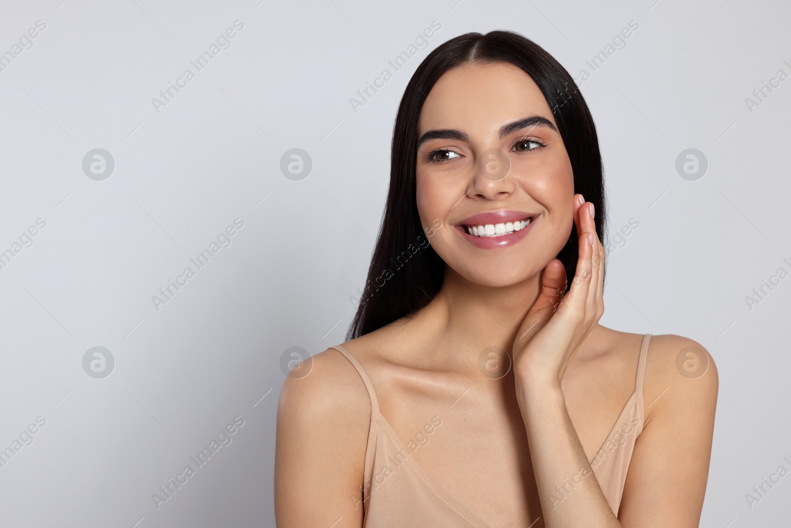 Photo of Portrait of attractive young woman on light grey background, space for text. Spa treatment