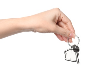 Woman holding house key with trinket on white background, closeup