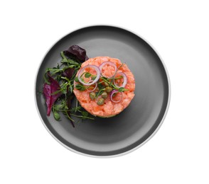 Photo of Tasty salmon tartare with red onion, basil, capers, microgreens and arugula isolated on white, top view