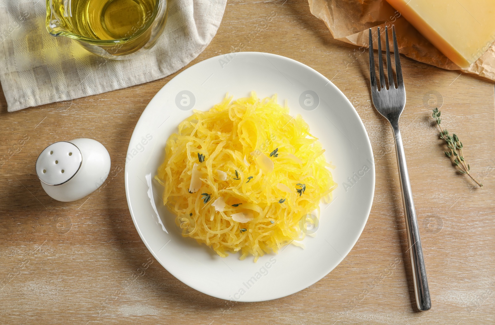 Photo of Flat lay composition with cooked spaghetti squash on wooden table