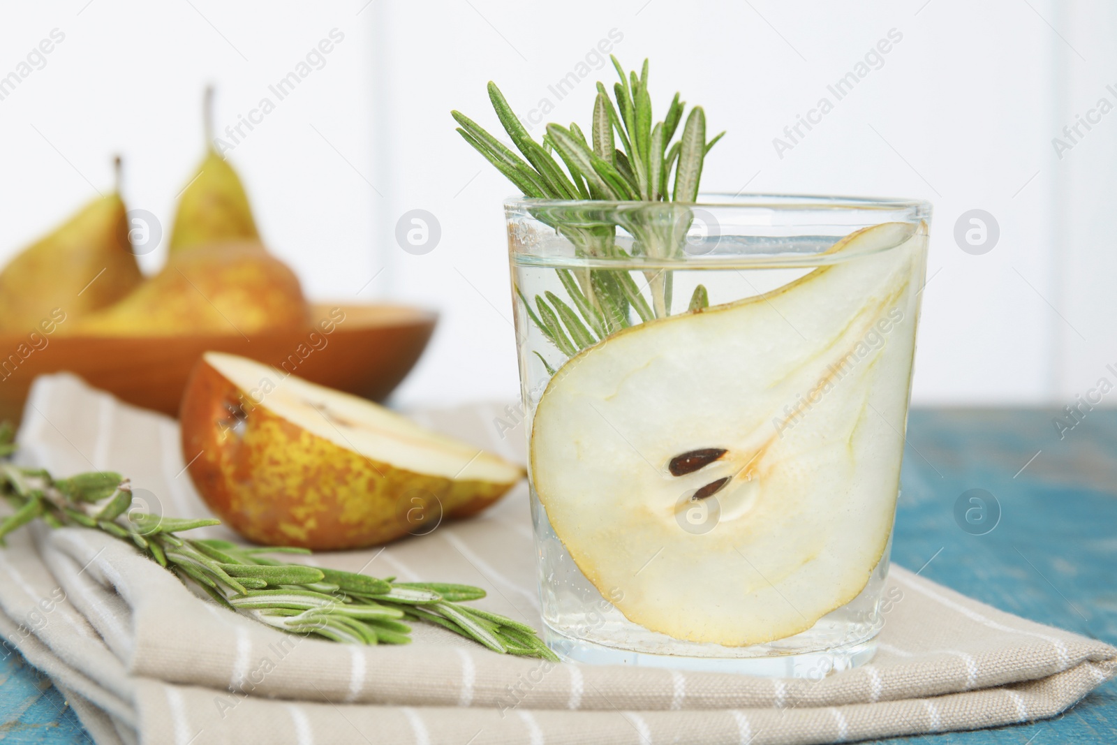 Photo of Refreshing pear cocktail with rosemary on table