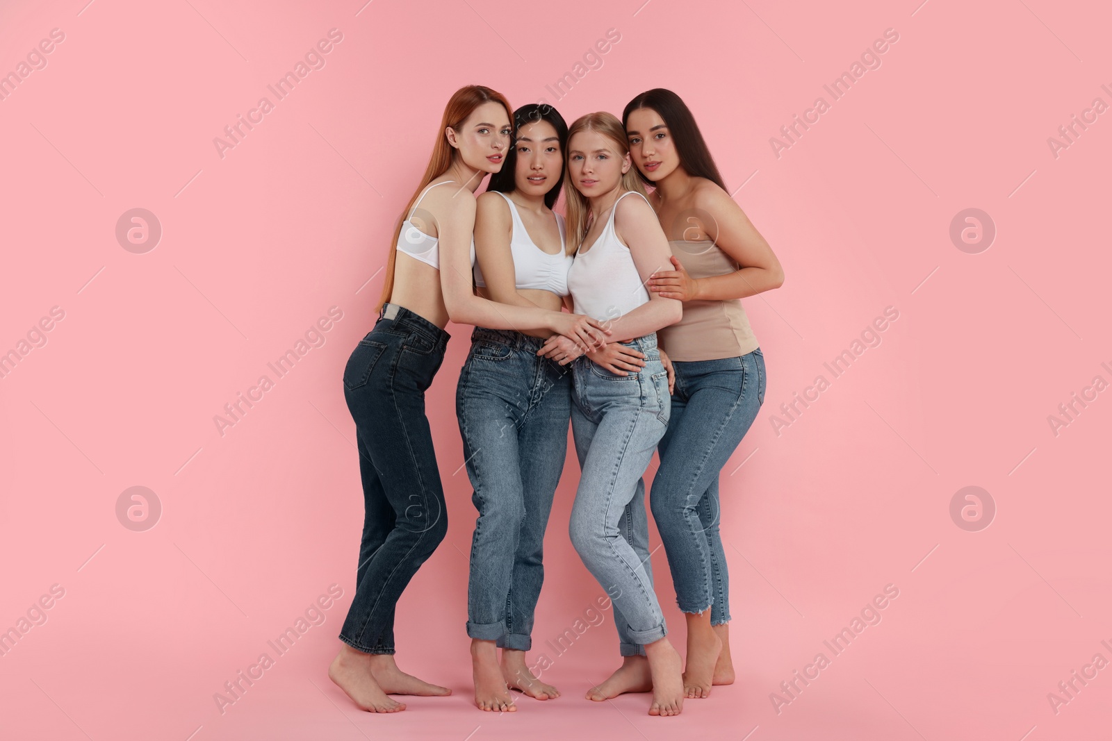 Photo of Group of beautiful young women on pink background