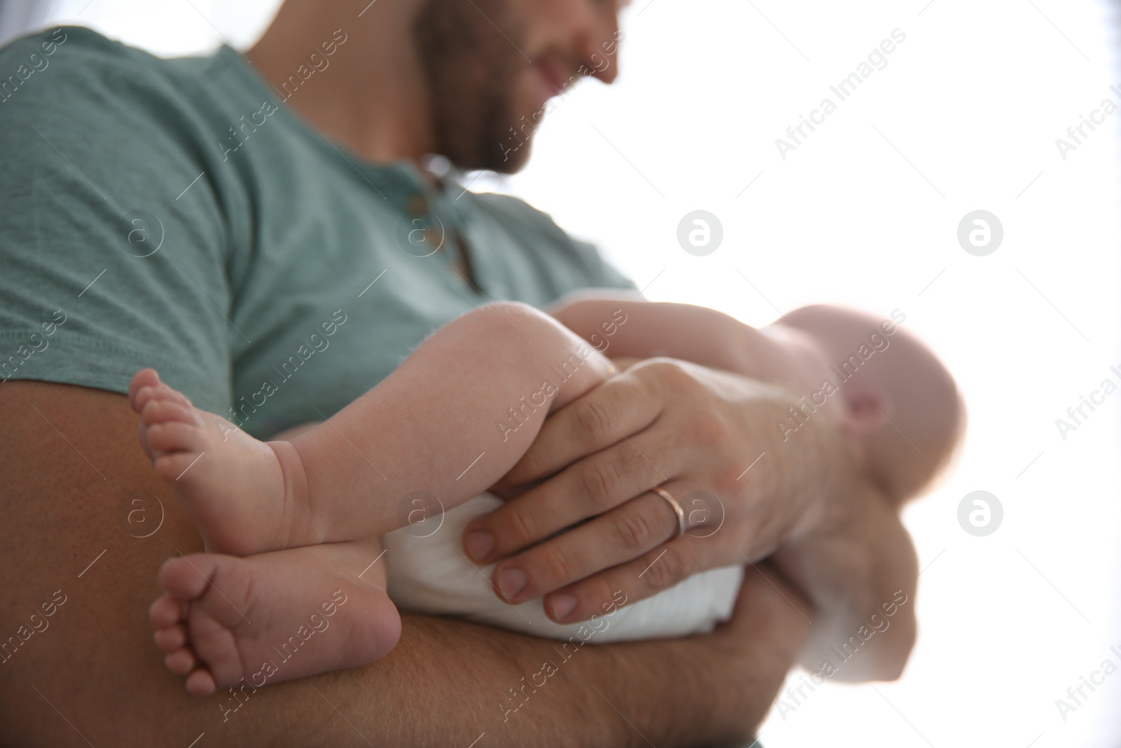 Photo of Father with his newborn son at home, closeup