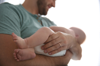 Photo of Father with his newborn son at home, closeup