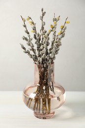 Photo of Beautiful pussy willow branches in vase on white table