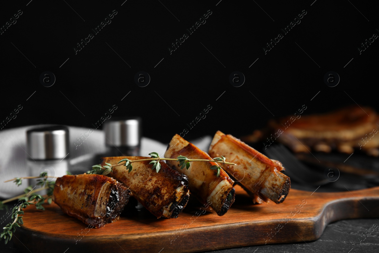 Photo of Delicious roasted ribs served on wooden board