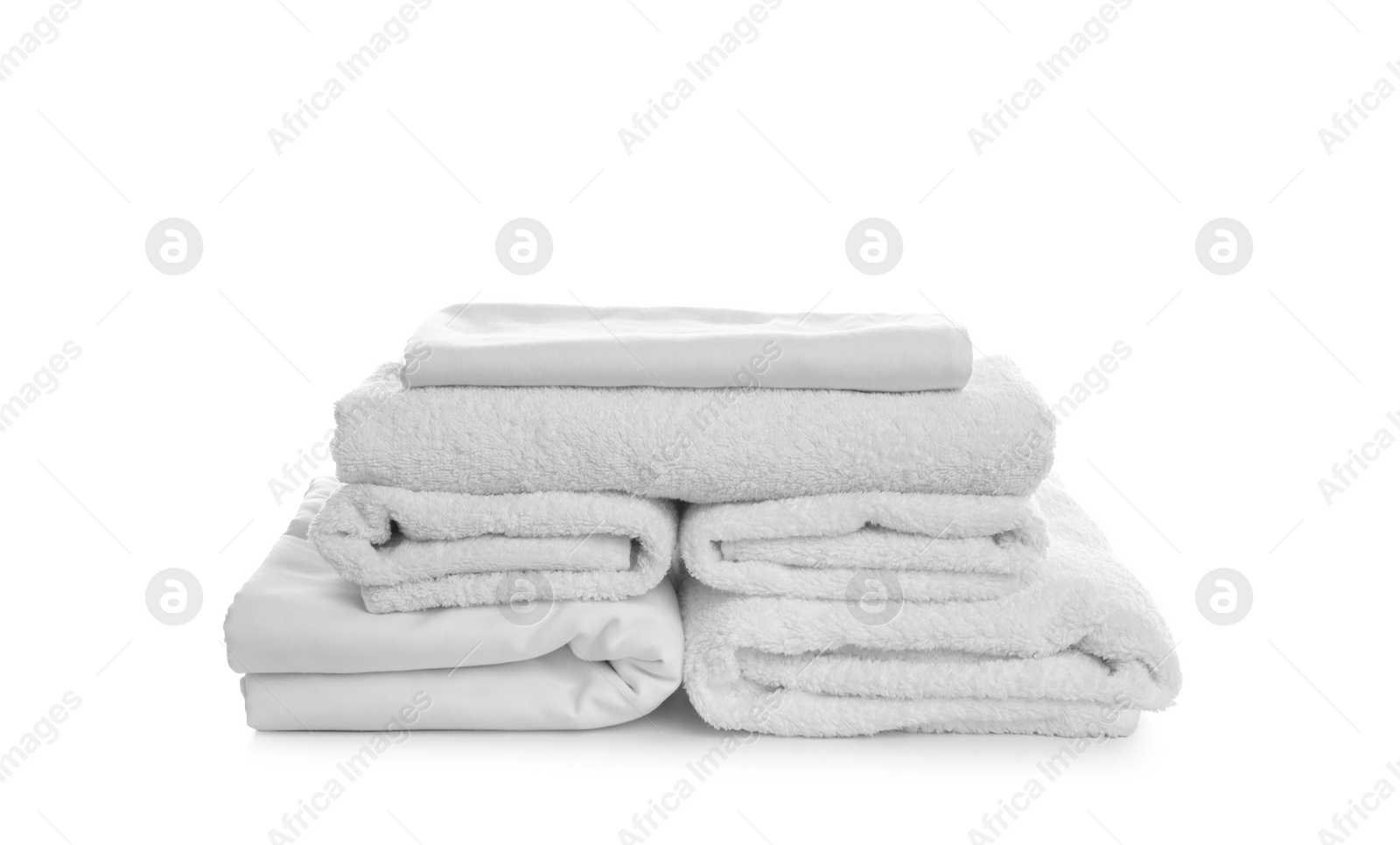 Photo of Stack of towels and bedding on white background