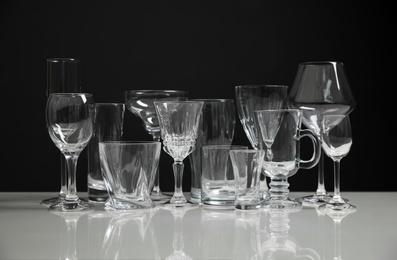 Photo of Set of bar glassware on white table against black background