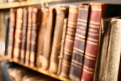 Blurred view of old books on shelf in library