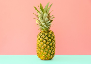 Photo of Fresh ripe pineapple on color background