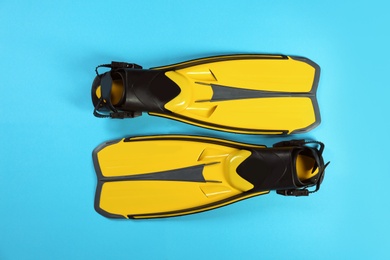 Swimming flippers on color background, top view
