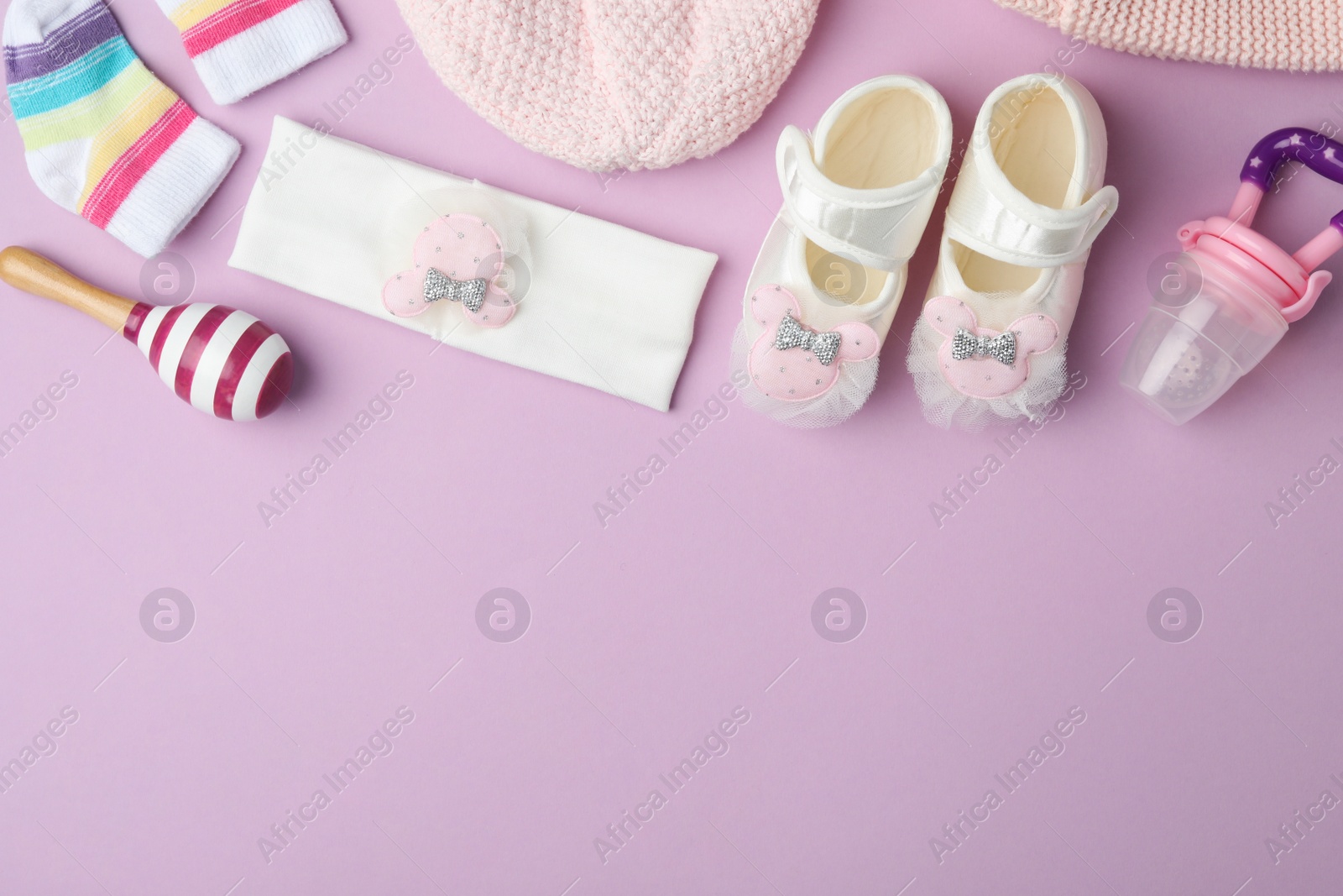 Photo of Flat lay composition with child's clothes and accessories on violet background, space for text