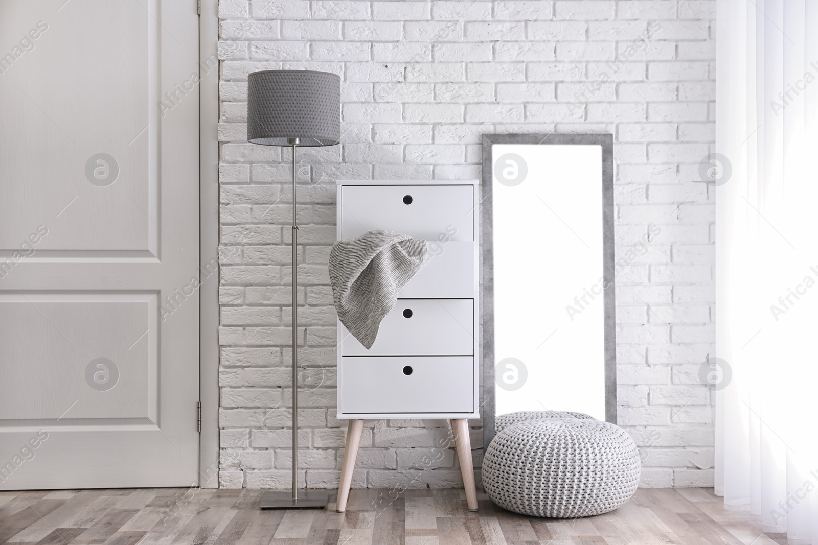 Photo of Modern room interior with large mirror and cabinet