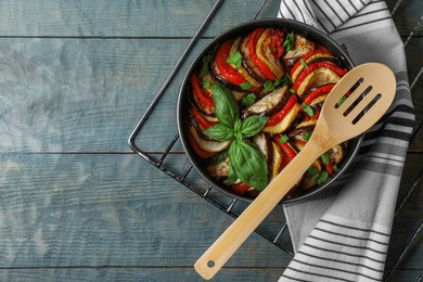 Delicious ratatouille on light blue wooden table, top view. Space for text