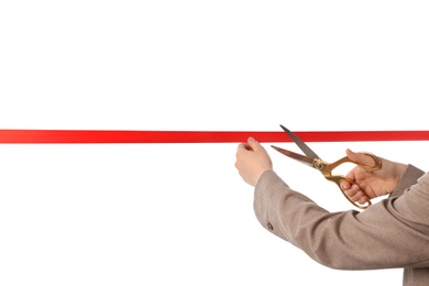 Photo of Woman in office suit cutting red ribbon isolated on white, closeup