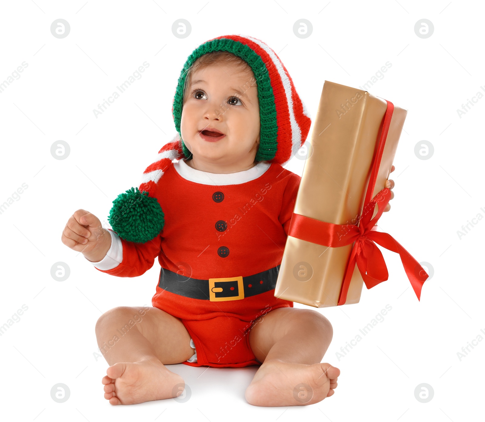 Photo of Festively dressed baby with gift box on white background. Christmas celebration