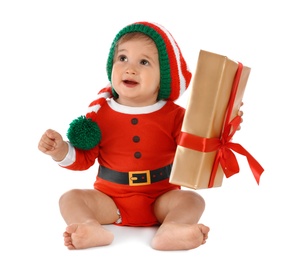 Photo of Festively dressed baby with gift box on white background. Christmas celebration